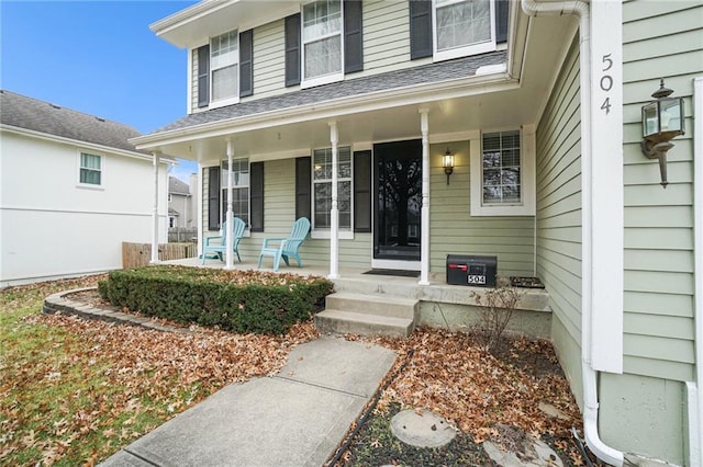 view of exterior entry with covered porch