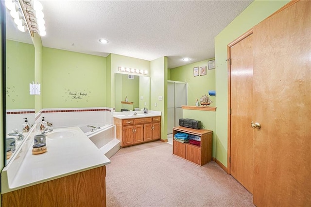 bathroom with vanity, a textured ceiling, and shower with separate bathtub