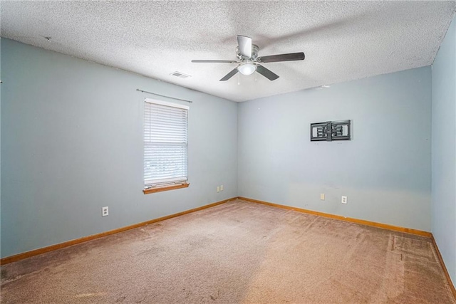 unfurnished room featuring carpet, a textured ceiling, and ceiling fan