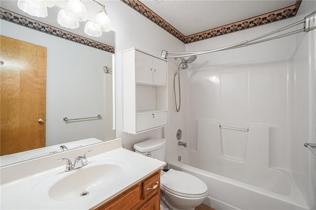 full bathroom with vanity, a textured ceiling, toilet, and tub / shower combination