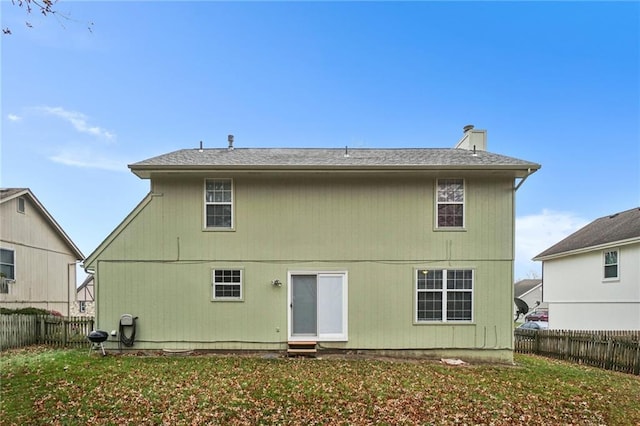 rear view of house with a yard