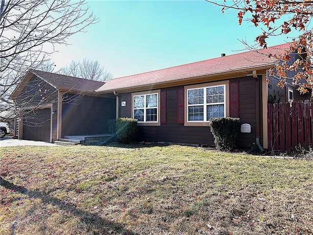 ranch-style house with a front yard and a garage