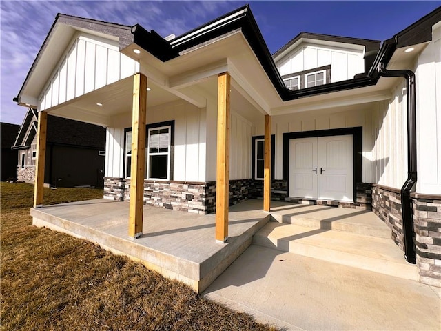 view of exterior entry with a porch