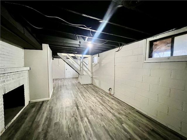 basement featuring a fireplace and hardwood / wood-style floors