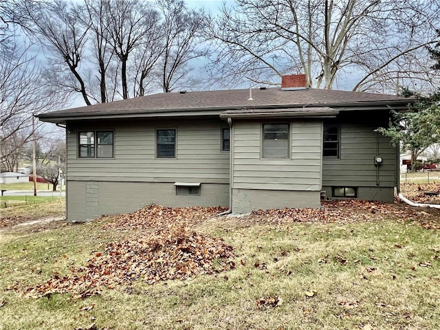 rear view of house featuring a yard