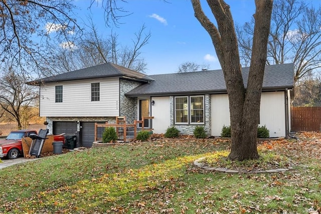 split level home with a front lawn and a garage