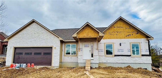 property under construction with a garage and stone siding