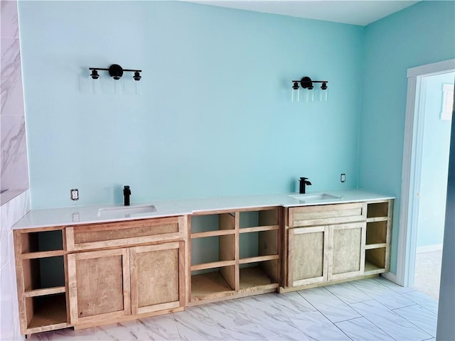 bathroom with marble finish floor and vanity
