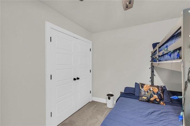 bedroom featuring light carpet and a closet