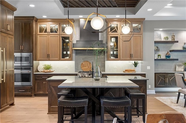 21359 W 93rd Ct, Lenexa, KS 66220 - kitchen with appliances with stainless steel finishes, backsplash, a breakfast bar, light wood-type flooring, and recessed lighting