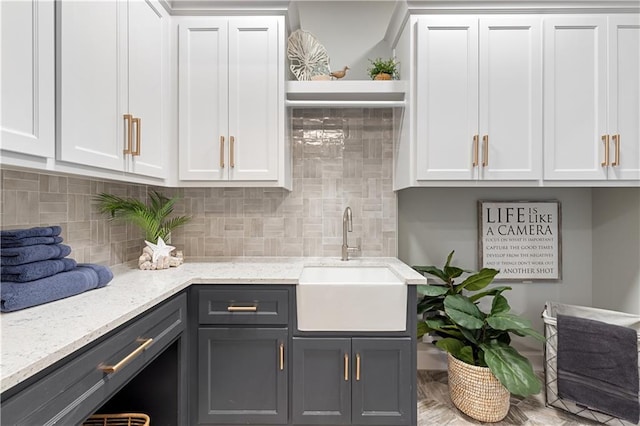 21359 W 93rd Ct, Lenexa, KS 66220 - kitchen with a sink, white cabinetry, tasteful backsplash, light stone countertops, and open shelves