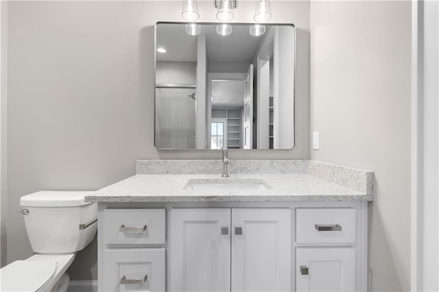 21359 W 93rd Ct, Lenexa, KS 66220 - bathroom featuring vanity, toilet, and a shower