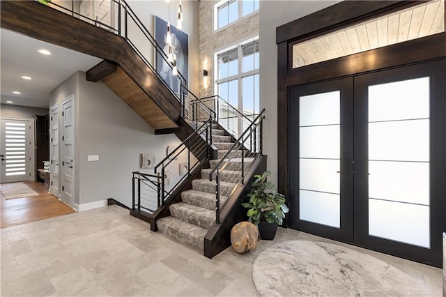 21359 W 93rd Ct, Lenexa, KS 66220 - foyer featuring french doors, stairway, healthy amount of natural light, recessed lighting, and baseboards