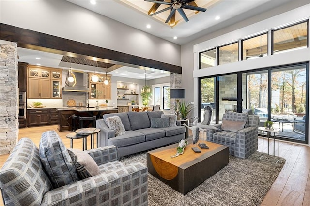 21359 W 93rd Ct, Lenexa, KS 66220 - living area with recessed lighting, light wood finished floors, a high ceiling, ceiling fan, and a raised ceiling