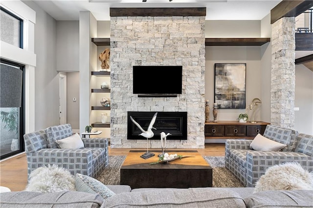 21359 W 93rd Ct, Lenexa, KS 66220 - living area featuring wood finished floors, a fireplace, built in shelves, and ornate columns