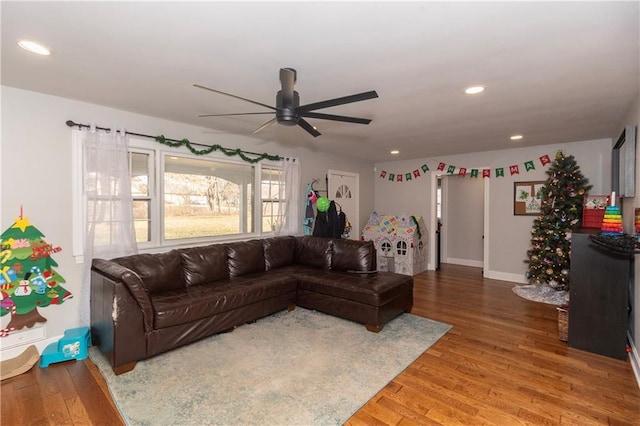 living room with ceiling fan and wood-type flooring