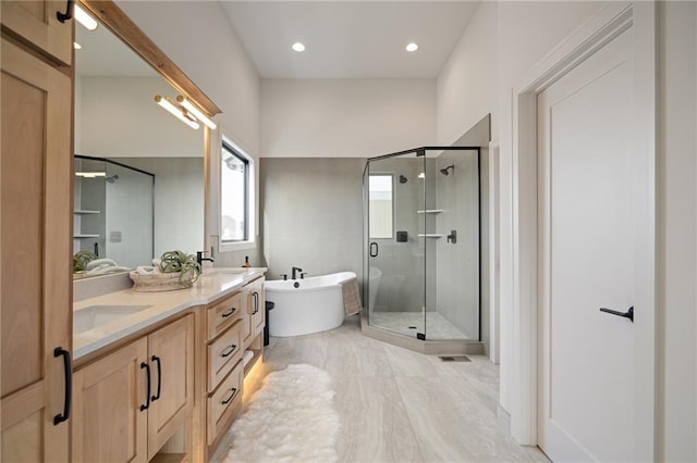 bathroom with shower with separate bathtub and vanity