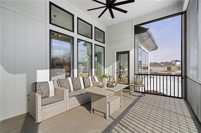 sunroom featuring ceiling fan