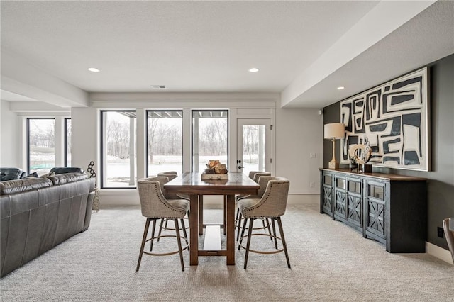 dining room with light carpet