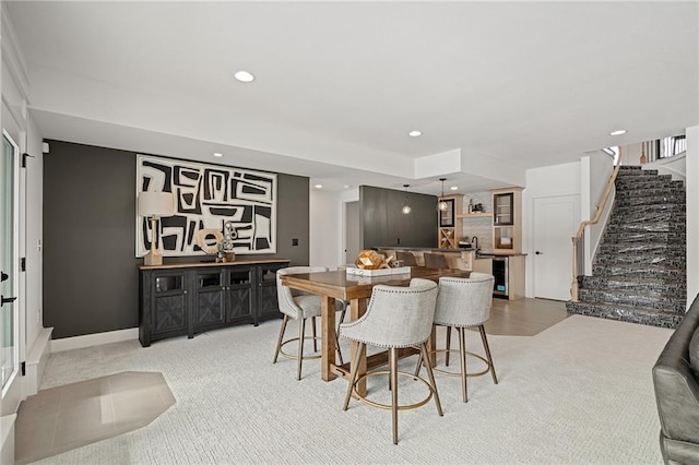 carpeted dining space featuring wine cooler