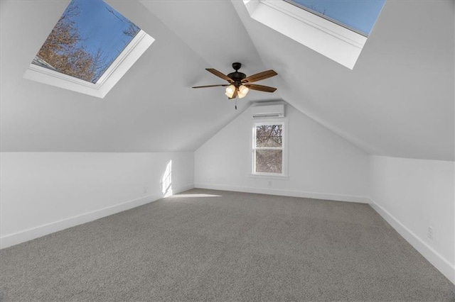 bonus room with vaulted ceiling with skylight, baseboards, carpet flooring, and a wall mounted AC