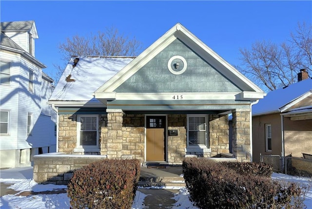 view of front of property with a porch and stone siding