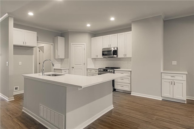 kitchen featuring appliances with stainless steel finishes, a center island with sink, and white cabinetry