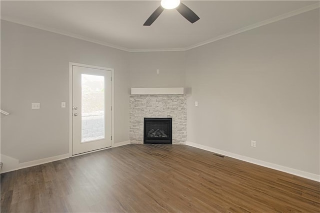 unfurnished living room with dark hardwood / wood-style floors, ceiling fan, ornamental molding, and a fireplace