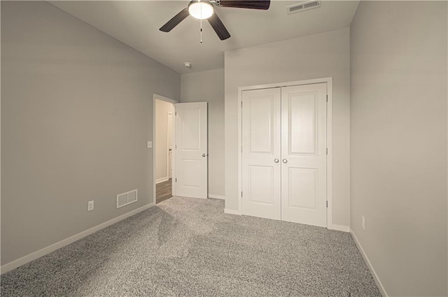 unfurnished bedroom featuring carpet flooring, ceiling fan, and a closet