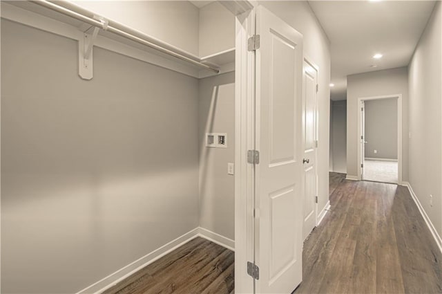 corridor with dark hardwood / wood-style flooring