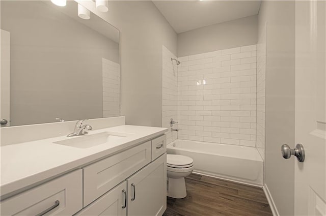 full bathroom featuring toilet, vanity, tiled shower / bath combo, and hardwood / wood-style flooring