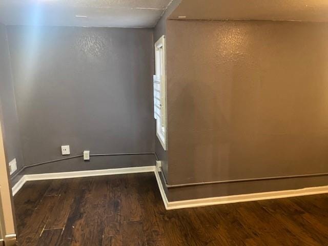 empty room with dark wood-type flooring