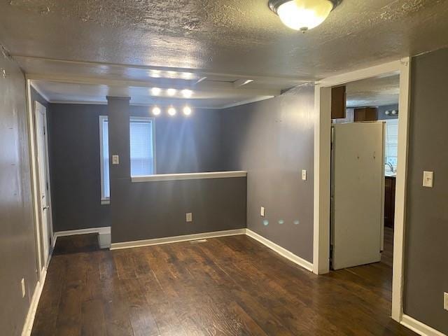 basement featuring a textured ceiling and dark wood-type flooring