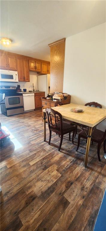 dining area with dark hardwood / wood-style floors