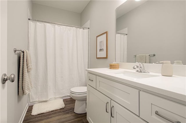 bathroom featuring vanity, wood-type flooring, and toilet