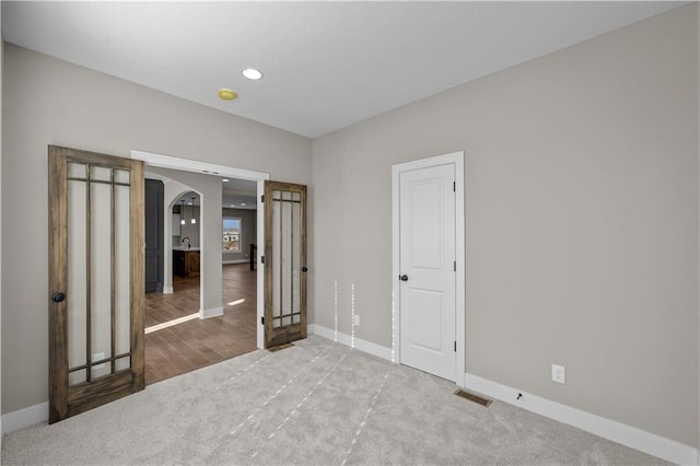 18580 W 169th Ter, Olathe, KS 66062 - unfurnished bedroom featuring arched walkways, carpet, and recessed lighting