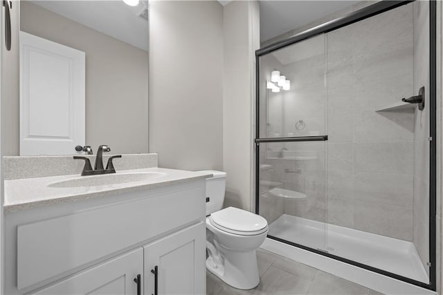 bathroom with tile patterned flooring, vanity, toilet, and an enclosed shower