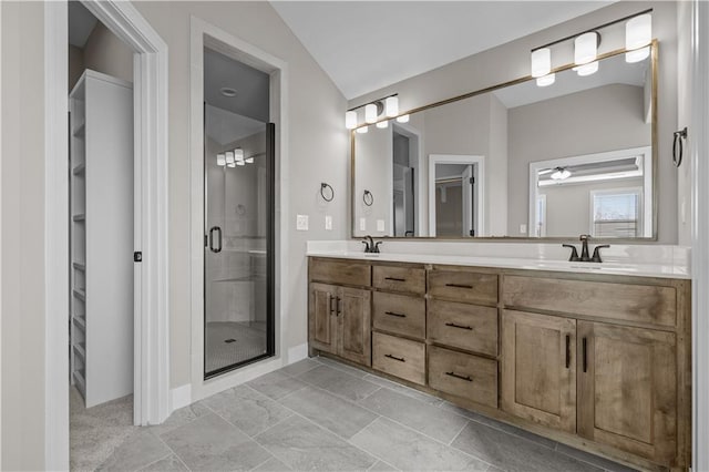 bathroom featuring vanity, vaulted ceiling, and walk in shower