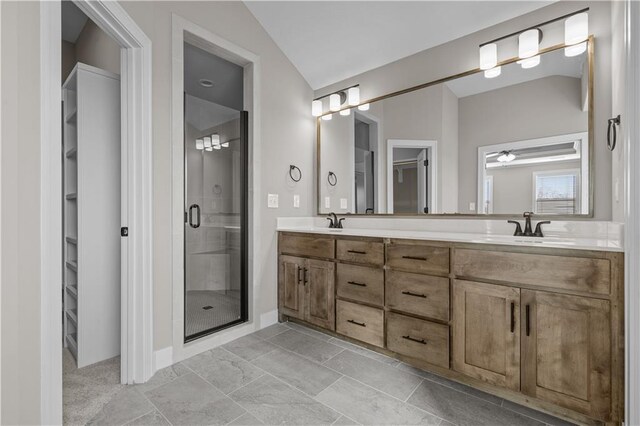 18580 W 169th Ter, Olathe, KS 66062 - bathroom with a shower stall, double vanity, vaulted ceiling, a spacious closet, and a ceiling fan