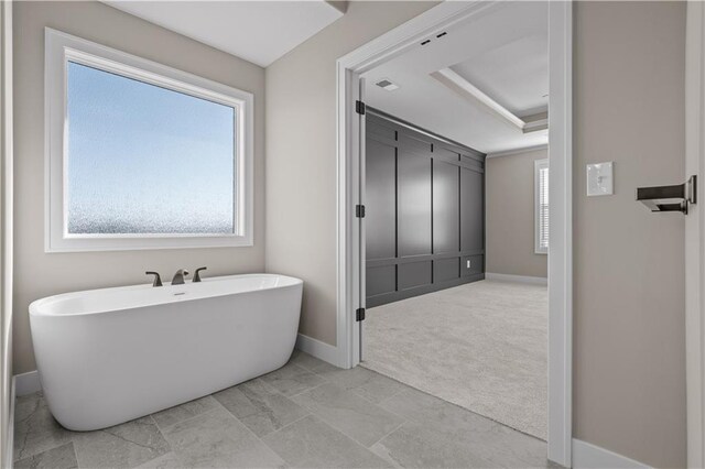 18580 W 169th Ter, Olathe, KS 66062 - bathroom with a freestanding bath and a raised ceiling