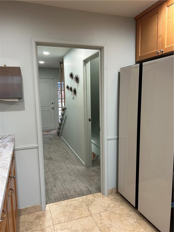 kitchen with light tile patterned flooring