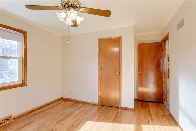 5032 NE 57th Ter, Kansas City, MO 64119 - unfurnished bedroom with wood finished floors, baseboards, crown molding, and a ceiling fan