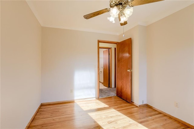 5032 NE 57th Ter, Kansas City, MO 64119 - spare room with a ceiling fan, light wood-type flooring, baseboards, and crown molding