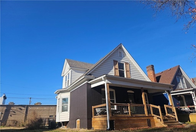 view of front of house with a porch and central AC