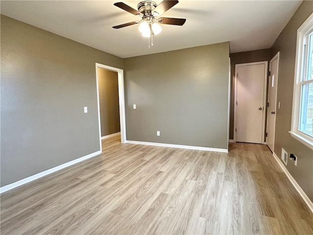 unfurnished room featuring light wood-type flooring and ceiling fan