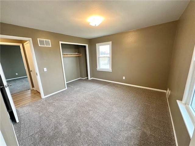 unfurnished bedroom featuring carpet flooring and a closet