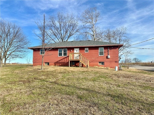 rear view of house with a yard