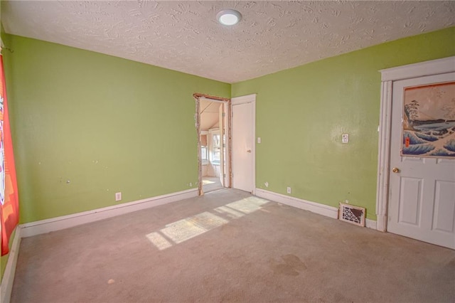 unfurnished bedroom with carpet floors and a textured ceiling