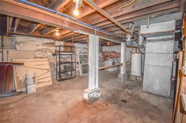 basement featuring washer / clothes dryer and water heater