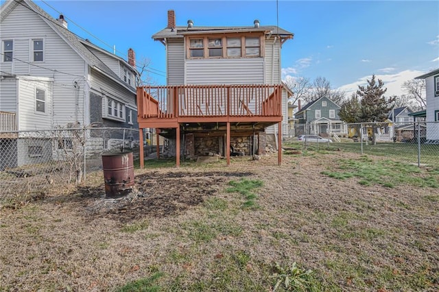 rear view of property featuring a wooden deck